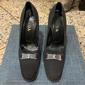 Prada black fabric high heel shoe with plastic Prada motif